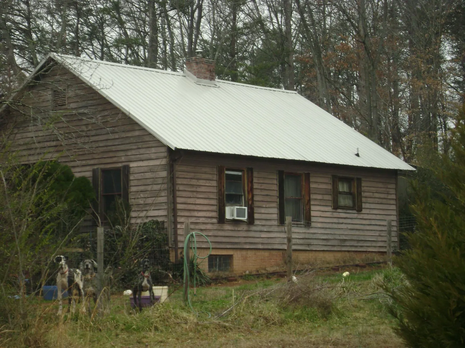 White metal roof on an old wood sided farmhouse, from a Metal Roof Installation job in New Ellenton